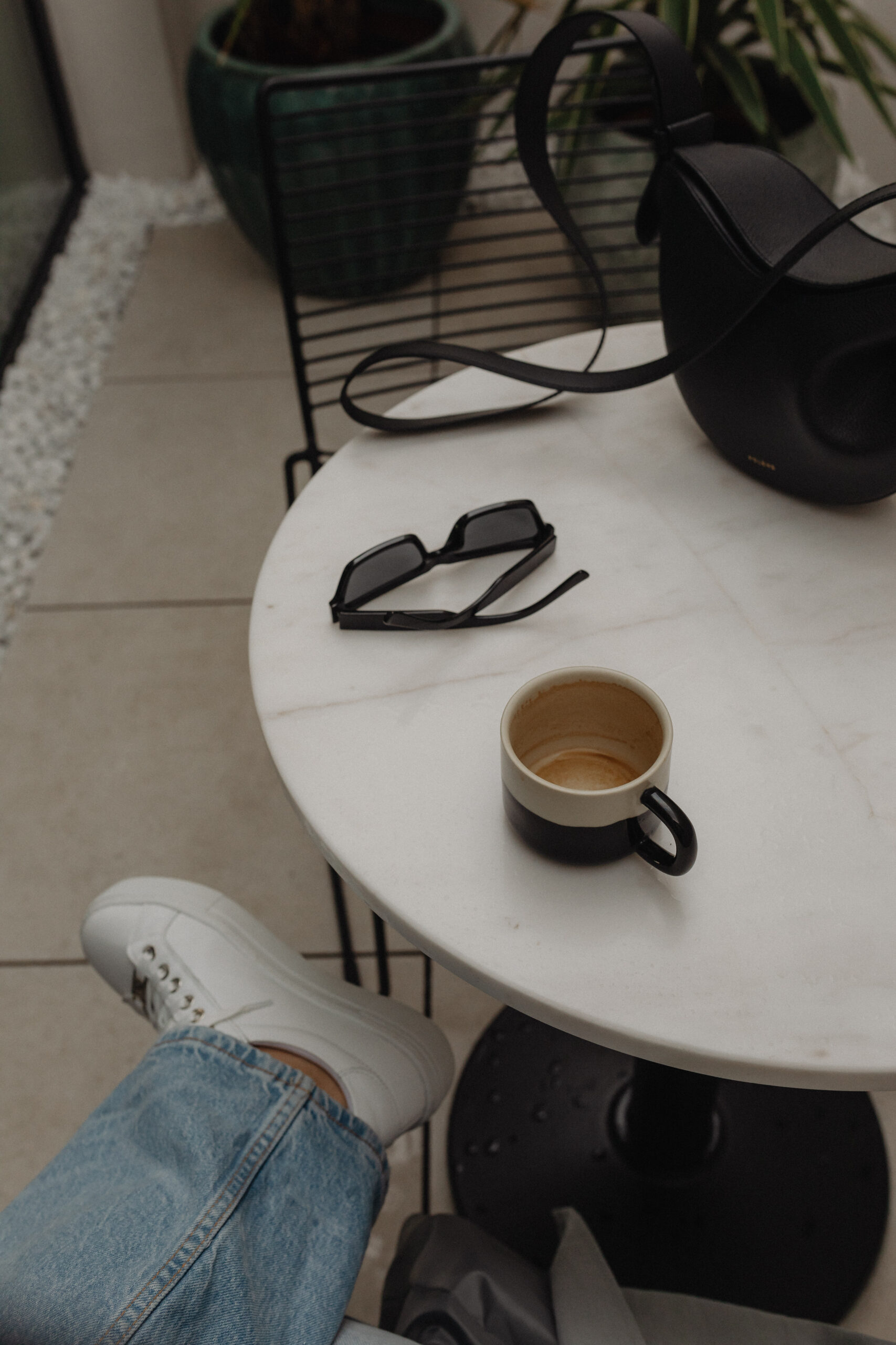 Kaboompics cozy indoor scene woman enjoying a cup of coffee at a white marble table 32599